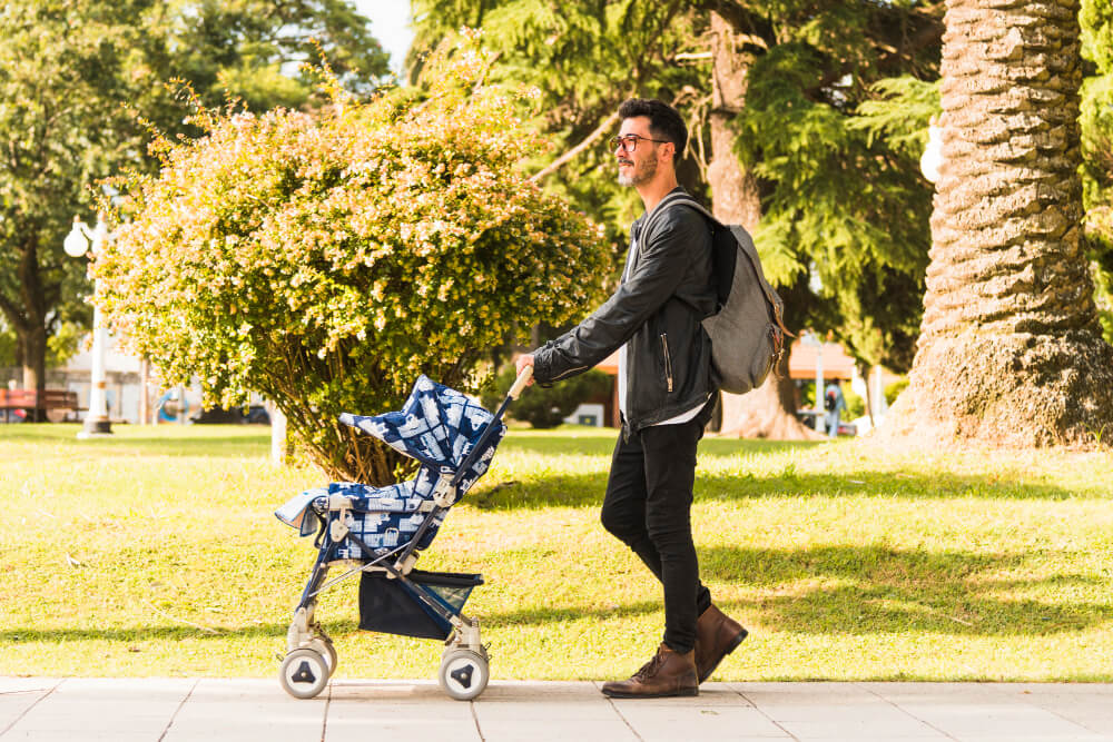 man with baby stroller